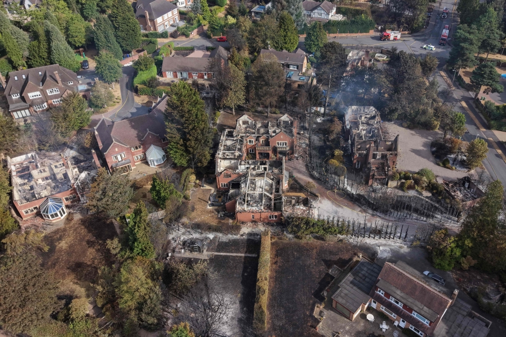 UK firefighters battle raging wildfires as heatwave scorches homes and puts thousands at risk