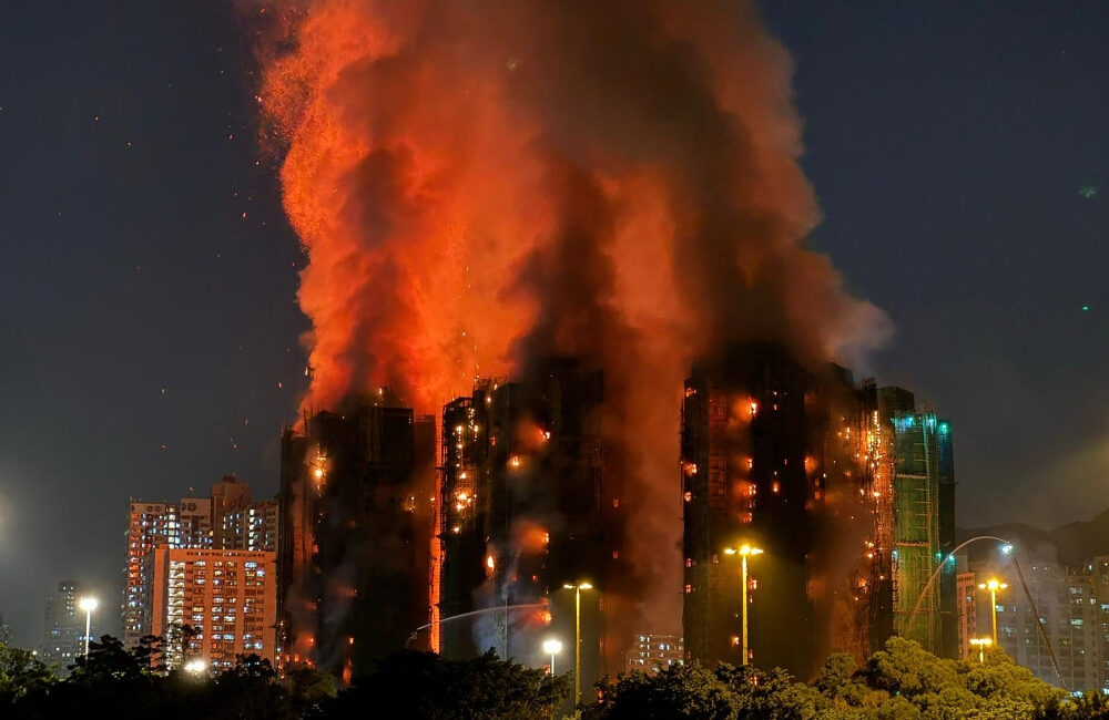 Hong Kong leader apologises for deadly blaze that killed 168 as housing minister resigns
